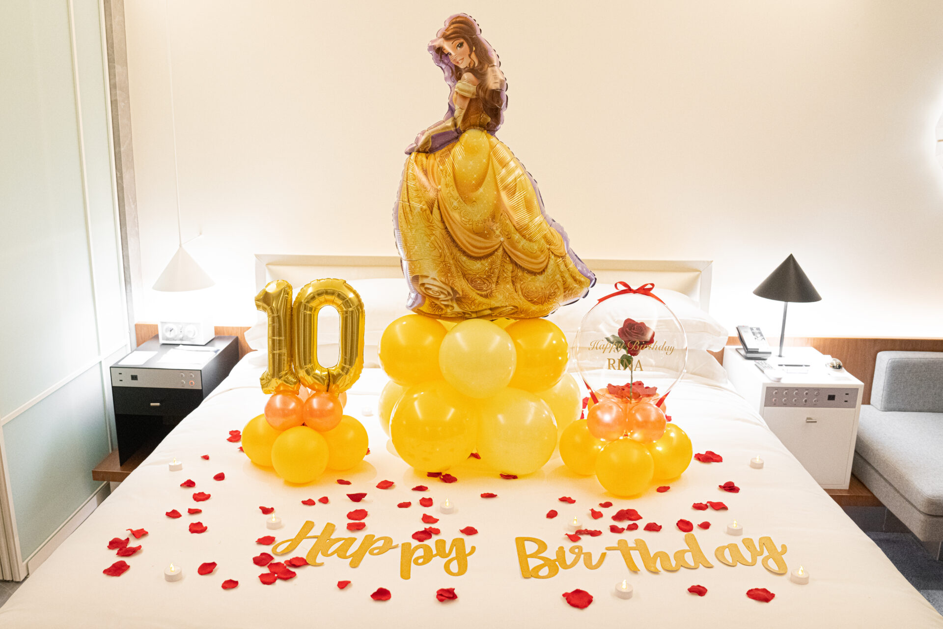 Birthday decorations with red roses and a theme of Belle, the princess from Beauty and the Beast